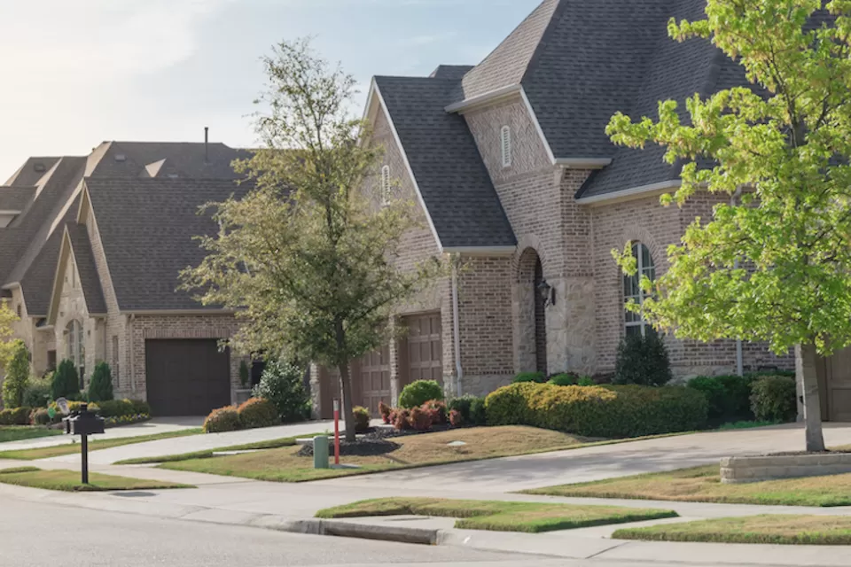 View of brick two-story houses in Dallas suburb